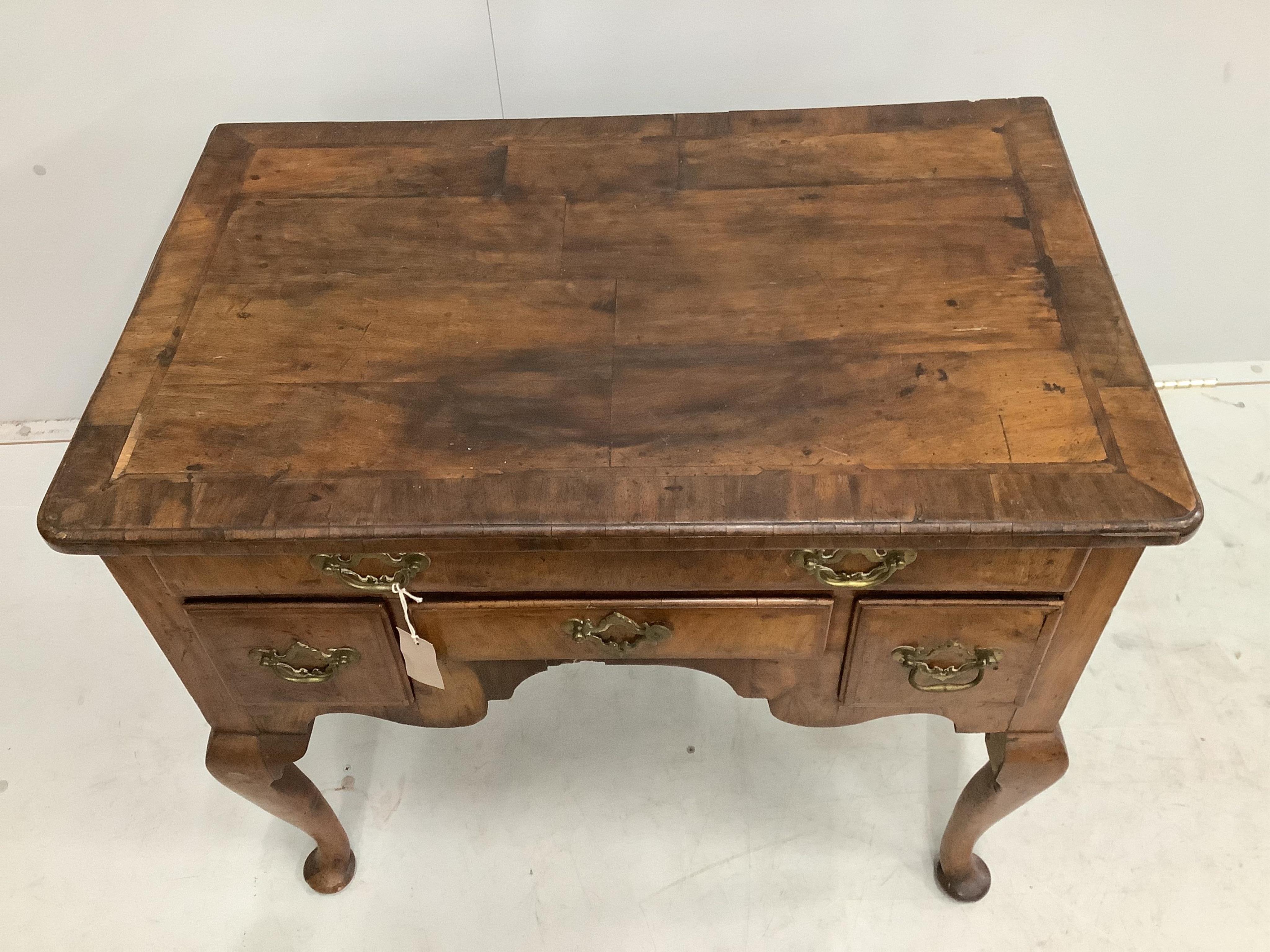 An 18th century feather banded walnut lowboy, width 81cm, depth 52cm, height 72cm